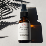 glass bottle of Shiva's Delight luxe flora facial serum. 